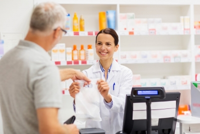 pharmacist and a customer smiling